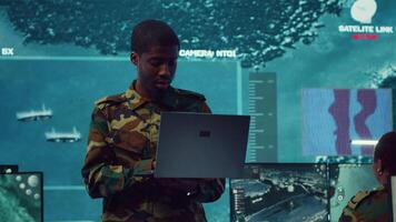 National guard machinist managing cybersecurity measures to protect federal government data from enemy breaches. Army troop conducting reconnaissance or demining operations. Camera A. video