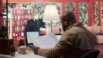 Businessman analyzing architecture blueprints for new office space layout, looking to relocate startup. Entrepreneur conducts an office hunt, business development and strategy planning. Camera B. video