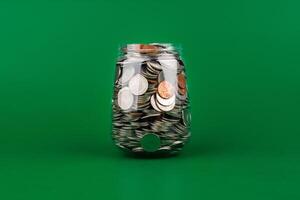 Saving coins in a glass jar creates a good financial and investment asset. Financial growth and investment returns photo