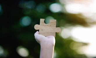 Wooden jigsaw puzzle, cooperation and teamwork, unity among groups and inspiration for good work. photo