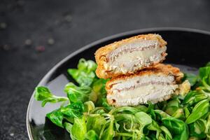 cutlet cordon bleu chicken meat, ham, cheese natural fresh appetizer meal food snack on the table copy space food background rustic top view photo