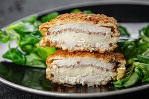 cutlet cordon bleu chicken meat, ham, cheese natural fresh appetizer meal food snack on the table copy space food background rustic top view photo