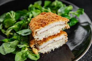 cutlet cordon bleu chicken meat, ham, cheese natural fresh appetizer meal food snack on the table copy space food background rustic top view photo