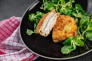 cutlet cordon bleu chicken meat, ham, cheese natural fresh appetizer meal food snack on the table copy space food background rustic top view photo