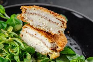 cutlet cordon bleu chicken meat, ham, cheese natural fresh appetizer meal food snack on the table copy space food background rustic top view photo