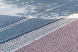 empty street with empty sidewalk photo