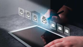 Woman use digital tablet with futuristic screen interface of mails. Communication and digital marketing. Inbox. Receiving electronic message alert. photo