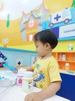 Positive activities for children playing in an indoor area filled with toy facilities and a place where they can find unlimited creativity photo