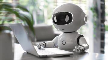 Cute AI chatbot robot sitting at desk and using laptop computer photo