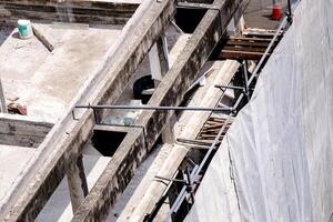 Unfinished construction structure, canvas to prevent dust spreading and disturbing others during construction. photo