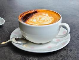a cup of the most aromatic, delicious cappuccino with lush chocolate foam photo