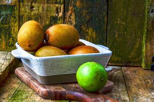 kiwi in a white ceramic bowl on a wooden background on a kitchen board photo