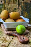 kiwi in a white ceramic bowl on a wooden background on a kitchen board photo