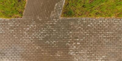 top view of the surface of wet paving slabs and pedestrian footpath after rain photo