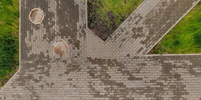 top view of the surface of wet paving slabs and pedestrian footpath after rain photo