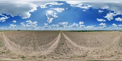 360 hdri panorama view on no traffic gravel road among fields in spring day with beautiful clouds in equirectangular full seamless spherical projection, ready for VR AR photo