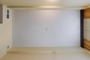suspended ceiling with halogen spots lamps and drywall construction in empty room in apartment or house. Stretch ceiling white and complex shape. photo