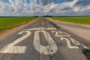 numbers 2024, 2025 on asphalt road highway. concept of destination in future, freedom, work start, run, planning, challenge, target, go, start, new year photo