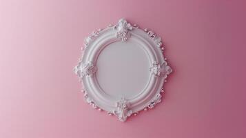 A photo frame, white empty mock up hanging on the pale pink wall in classic style.