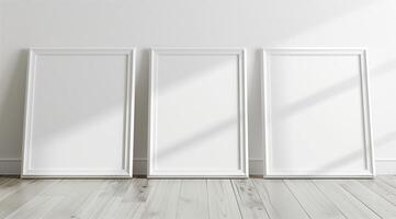 Front view of three white minimalistic picture frames on a light background. photo