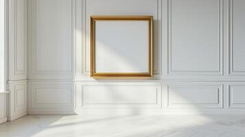 A blank gold picture frame hanging on a wall in a classical interior with white paneling and light wood floors. photo