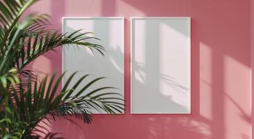 Two vertical white frame mockups on pink wall and large plant next to it. photo