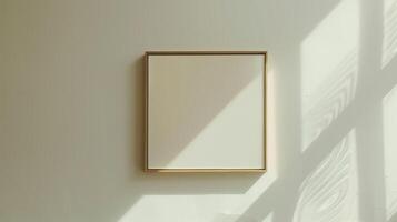 A thin gold frame on a white wall. photo