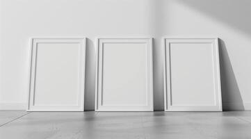 Front view of three white minimalistic picture frames on a light background. photo