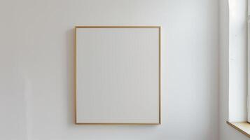 A thin gold frame on a white wall. photo