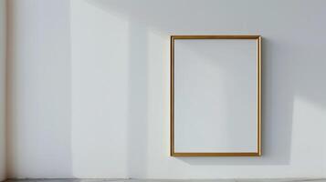 A thin gold frame on a white wall. photo