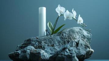 A white skincare product placed on a huge rock with a white orchid and a butterfly. photo