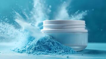 A dental powder products in a white jar with lid open, surrounded by light blue powder dust. photo