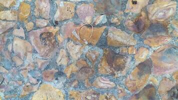 photo of a tile material texture made from chunks of stone of different sizes and colors creating a distinctive shape