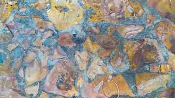 photo of a tile material texture made from chunks of stone of different sizes and colors creating a distinctive shape