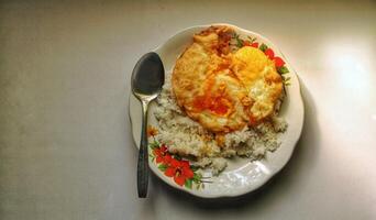 A simple morning dish of hot white rice with fried duck eggs photo