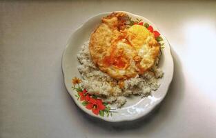 A simple morning dish of hot white rice with fried duck eggs photo