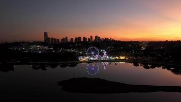 Curitiba in Parana, Brazil. Aerial View. Wonderful sunset with views of buildings and Tangua Park. Lake with reflection. video