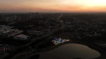 Curitiba in Parana, Brazil. Aerial View. Wonderful sunset with views of buildings and Tangua Park. Lake with reflection. video