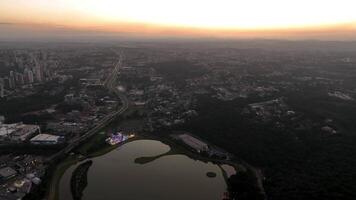 Curitiba in Parana, Brazil. Aerial View. Wonderful sunset with views of buildings and Tangua Park. Lake with reflection. video