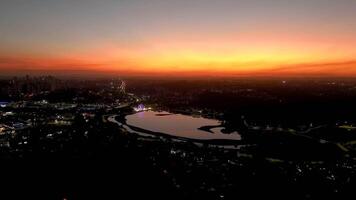 Curitiba in Parana, Brazil. Aerial View. Wonderful sunset with views of buildings and Tangua Park. Lake with reflection. video