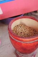Farmers use wooden mortars and pestles to break the husks apart from the coffee beans to remove unwanted husks from coffee beans before processing them to produce high quality coffee beans for export. photo