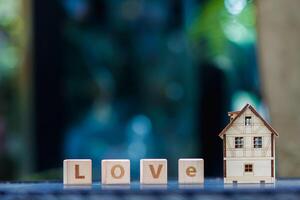 wooden blocks with word love are arranged to indicate meaning I love you and are also symbol of love and friendship for one another. Wooden blocks with word love are arranged on glass table. photo