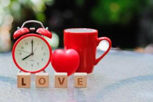 wooden blocks with word love are arranged to indicate meaning I love you and are also symbol of love and friendship for one another. Wooden blocks with word love are arranged on glass table. photo
