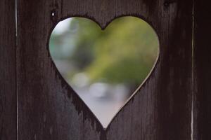 background is a heart-shaped piece of wood, which means I love you and is also a symbol of love and friendship for one another. A heart-shaped stencil on the background was used to decorate the venue. photo