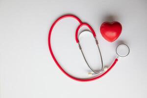Doctors use stethoscope to listen patient heartbeat to find faults in heart disease. Doctors use stethoscope to listen patient heart rate to gather information diagnose disease and provide treatment. photo