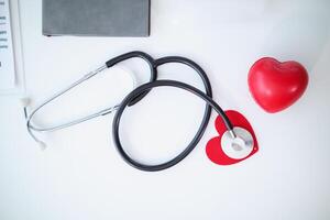 Doctors use stethoscope to listen patient heartbeat to find faults in heart disease. Doctors use stethoscope to listen patient heart rate to gather information diagnose disease and provide treatment. photo