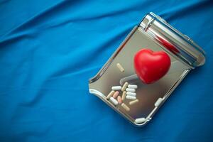 realistic looking heart model on the table of doctor is symbol of campaign to care for health of heart disease patients and encourage people at risk of heart disease to come in for regular check ups. photo
