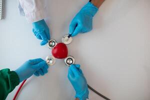 Doctors use stethoscope to listen patient heartbeat to find faults in heart disease. Doctors use stethoscope to listen patient heart rate to gather information diagnose disease and provide treatment. photo