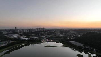 Curitiba in Parana, Brazil. Aerial View. Wonderful sunset with views of buildings and Tangua Park. Lake with reflection. video
