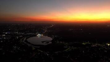 Curitiba in Parana, Brazil. Aerial View. Wonderful sunset with views of buildings and Tangua Park. Lake with reflection. video